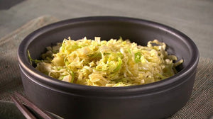 Shredded Saku Saku Cabbage Salad in a Black Ceramic Bowl